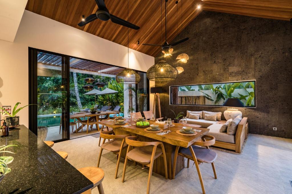 a living room with a table and a couch at Villa Welcome by BaliSuperHost in Ubud
