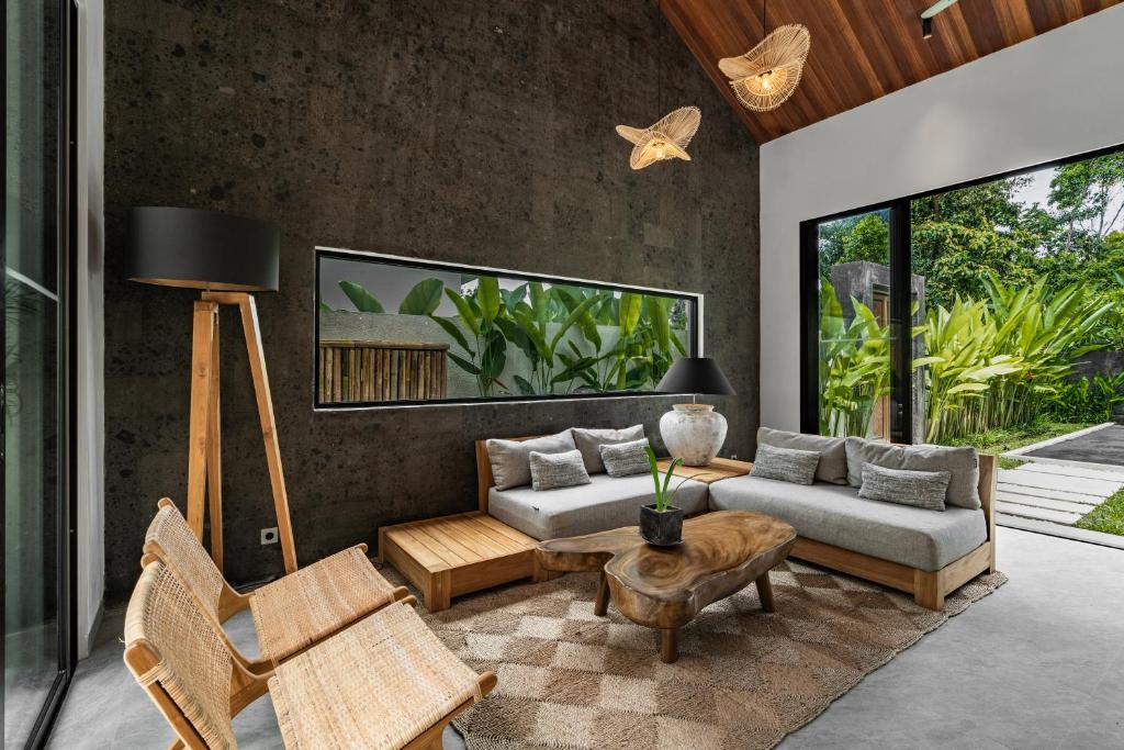 a living room with a couch and a table at Villa Welcome by BaliSuperHost in Ubud