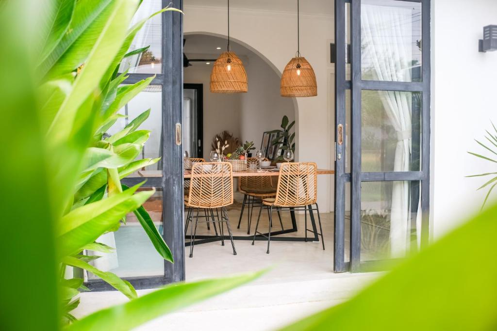 a dining room with a table and chairs at Villa Naia Berawa in Canggu
