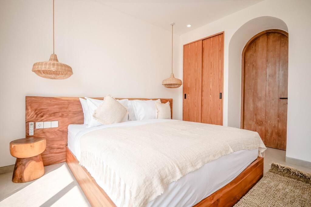 Tempat tidur dalam kamar di Maison Coucou - Modern Minimalist 3BR Villa near Tanah Lot