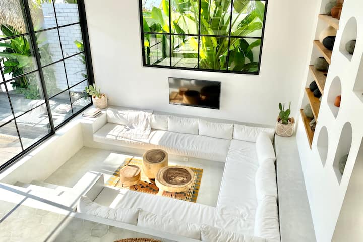 Modern tropical home decorating package featuring rattan furniture, teak wood accents, boho textiles, outdoor loungers, and artisanal décor for stylish villas.