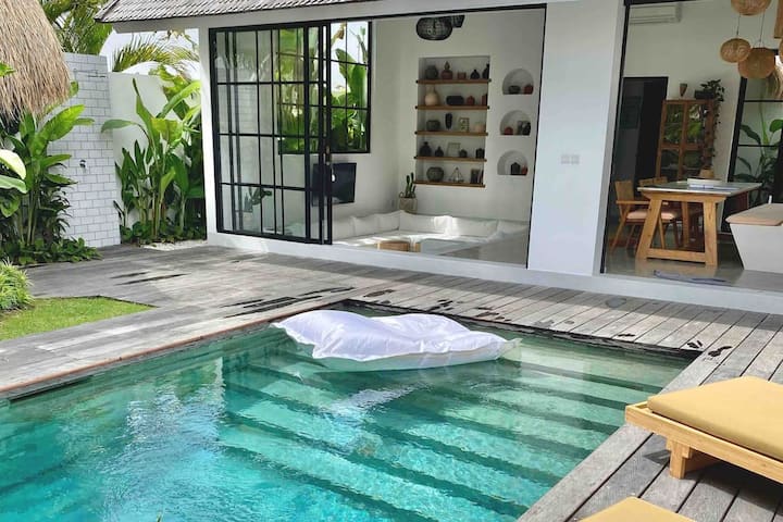 Modern tropical home decorating package featuring rattan furniture, teak wood accents, boho textiles, outdoor loungers, and artisanal décor for stylish villas.