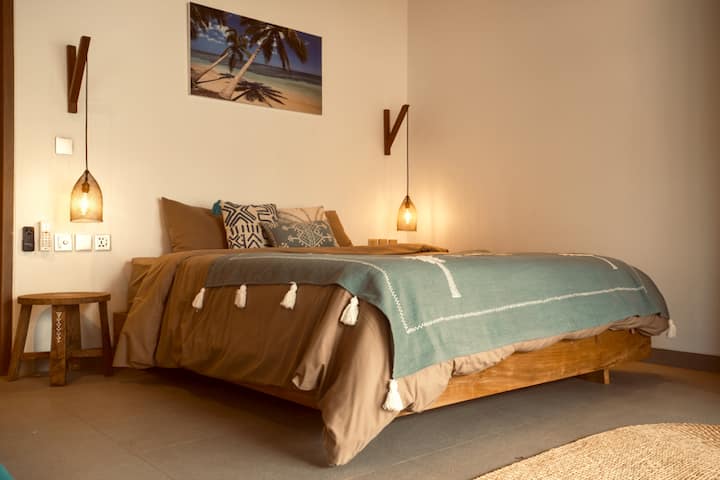 Bedroom two is furnished with a king-sized bed and is fully equipped with both fans and air-conditioning.